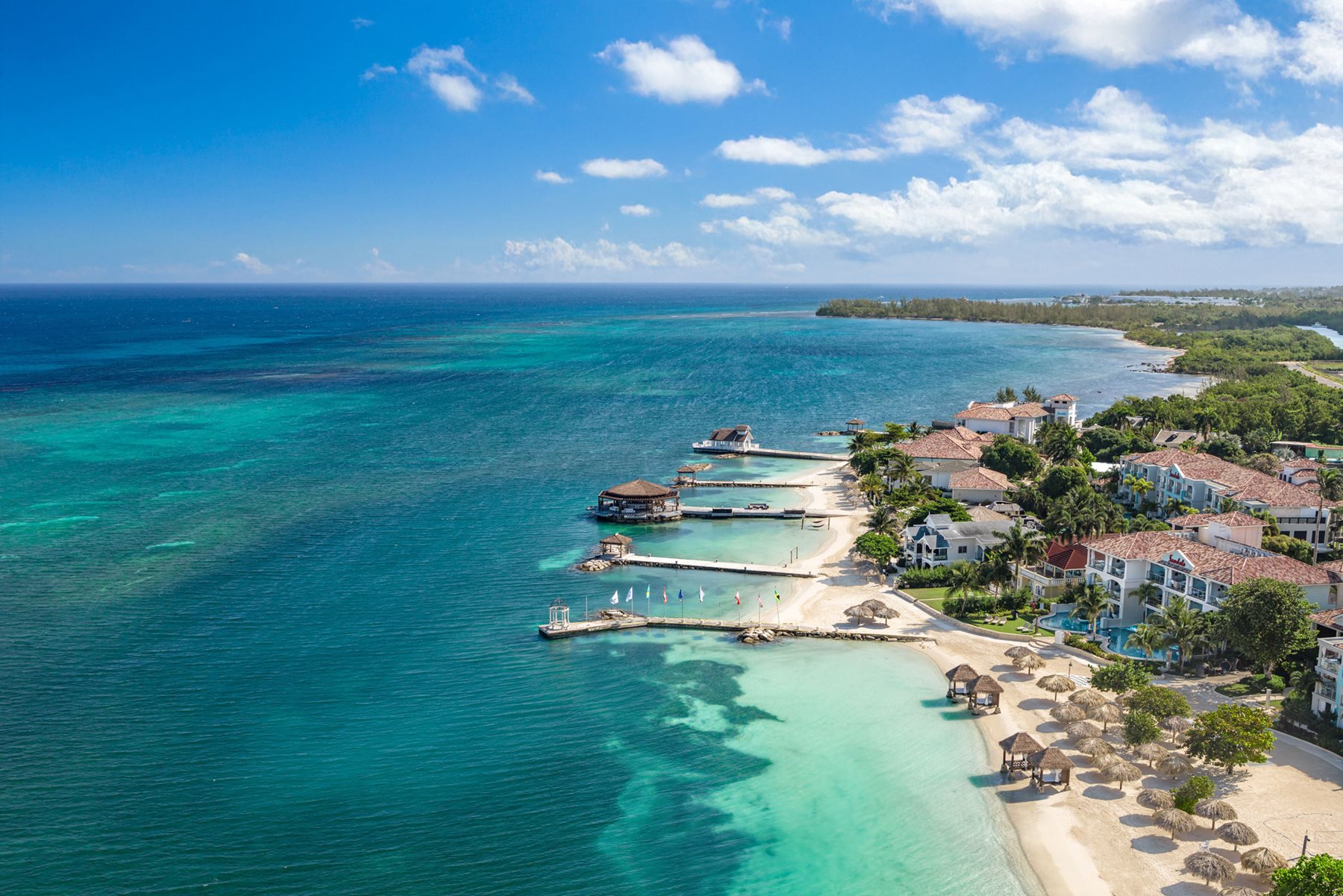 Aerial view of the Montego Bay coastline — turquoise water, white sand and beachfront resorts